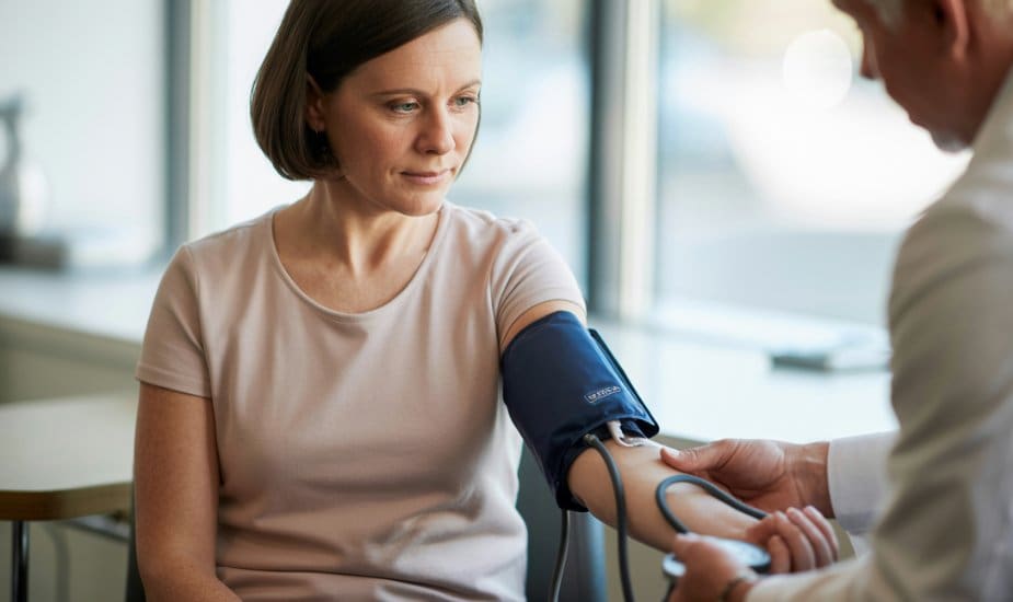 A woman having her blood pressure checked during a consultation at a modern London clinic
